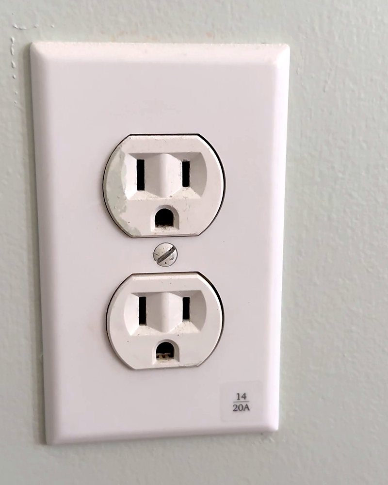 A finished receptacle cover with a Clear Label reading 14 over 20A, its breaker number and amperage